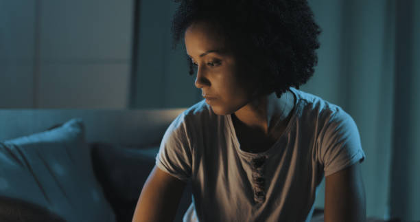 istock Sad woman sitting on bed at night 1356524087