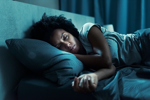 Mujer afroamericana durmiendo en su cama photo