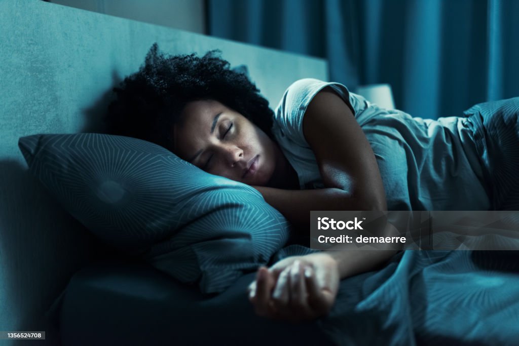 African american woman sleeping in her bed Beautiful african american woman sleeping in her bed at night Sleeping Stock Photo