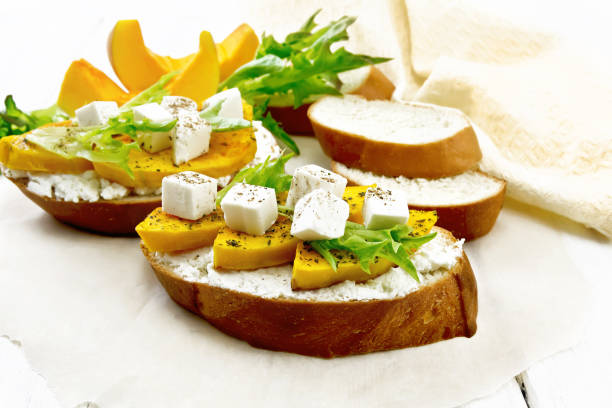 istock Bruschetta with pumpkin and ricotta on white board 1356525166