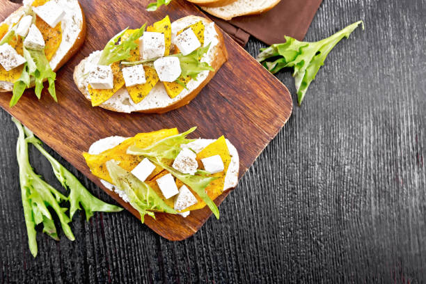 istock Bruschetta with pumpkin and arugula on board top 1356525167