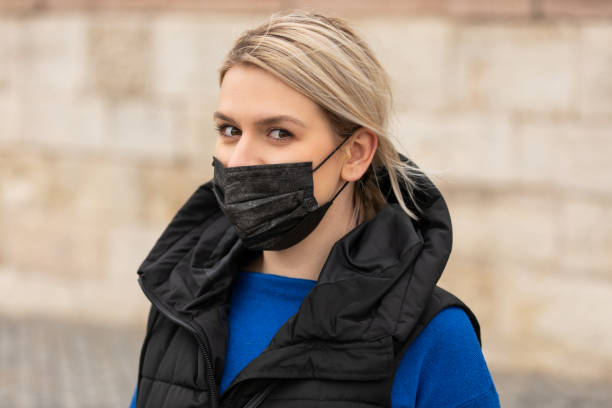 istock Woman with mask outdoor 1356527856