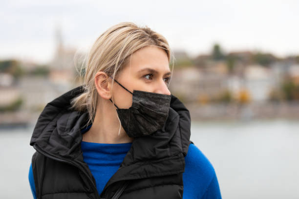istock Woman with mask outdoor 1356527892