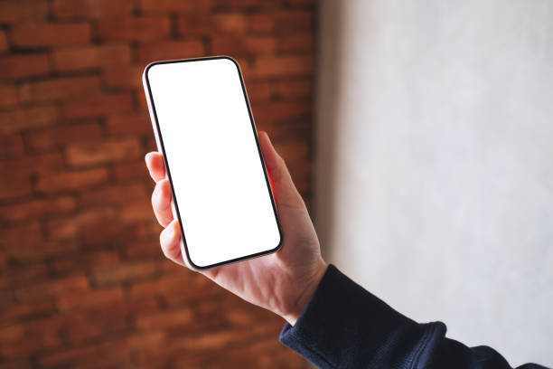 istock a woman holding mobile phone with blank desktop screen 1356528524