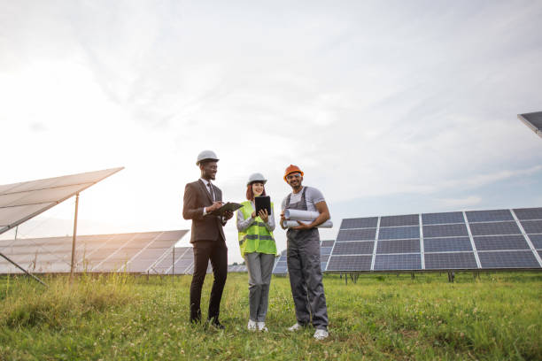 istock Indian technician standing at solar farm with two inspectors 1356529097