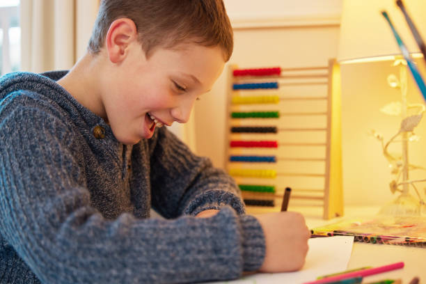istock Shot of a young boy completing his homework 1356529190