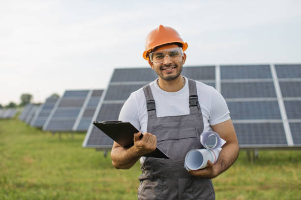 istock Portrait of indian engineer in uniform posing at solar farm 1356529602