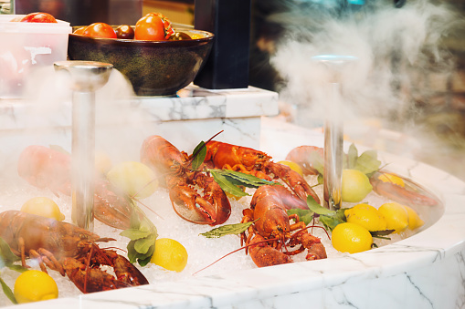 Lobsters leaning on ice with lemons in London restaurant