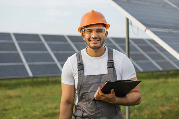 istock Male professional engineer in uniform controlling work on solar farm 1356529928