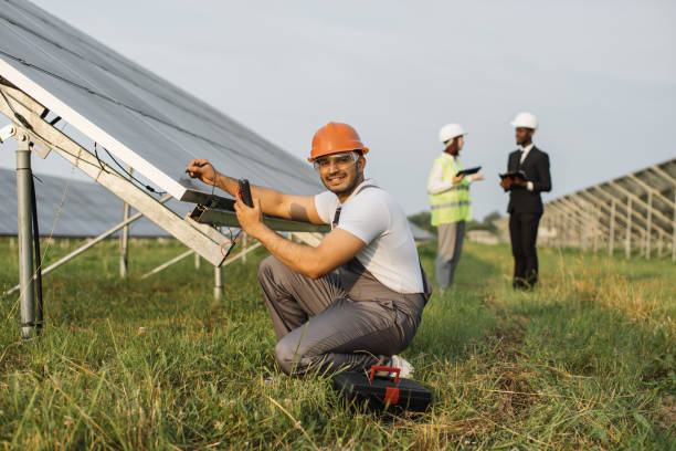 istock Indian man sitting near solar panel with multimeter in hands 1356531949
