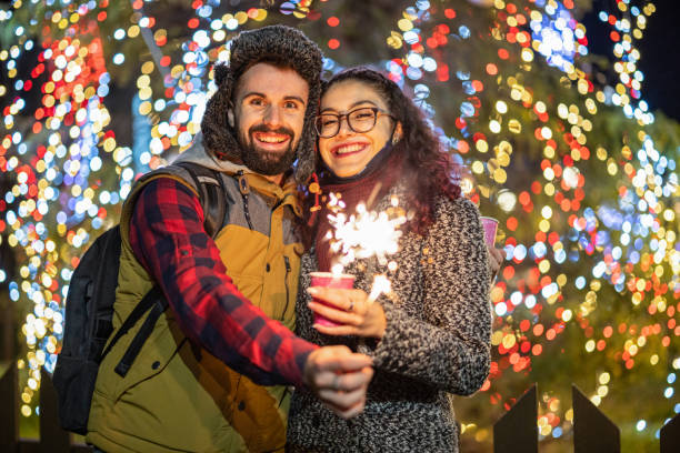 istock Smiling couple celebrating Christmas together 1356532190