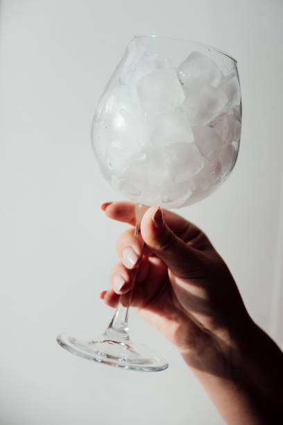 istock A woman's hand holds a glass with ice 1356534734