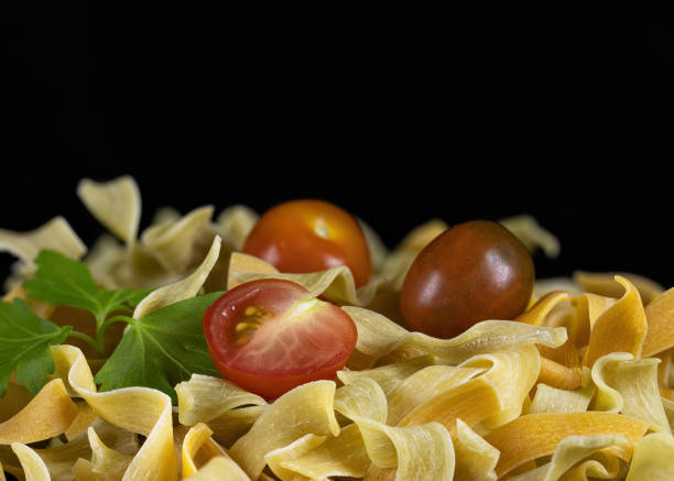 Homemade egg paste with cherry tomatoes and parsley on a black background.