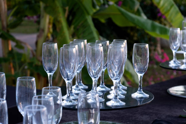 istock Empty glasses for sparkling wine on black table. Selective focus. Catering service. Holding events or celebrations in the open air 1356538123