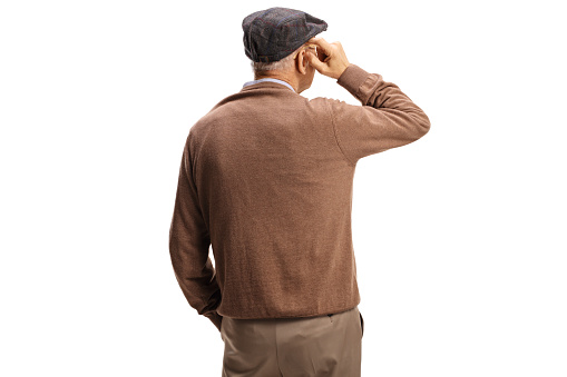 Rear view shot of a pensive elderly man standing and thinking isolated on white background