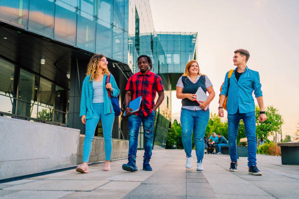 istock Friends walking in university campus 1356539500