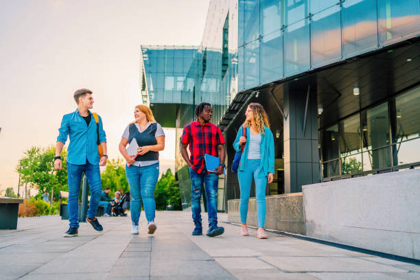 istock Friends walking in university campus 1356540180