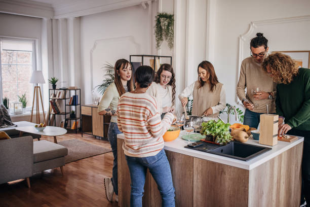 Friends preparing a meal together stock photo