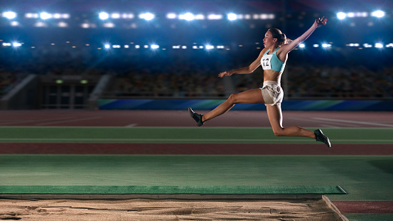 Long Jump Championship: Professional Female Athlete Jumping on Long Distance. Determination, Motivation, Inspiration of a Successful Sports Woman Setting New Record Result. Competition on Big Stadium.