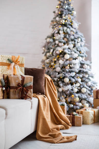 istock Interior of bright modern living room with comfortable sofa decorated with Christmas tree and gifts 1356541636
