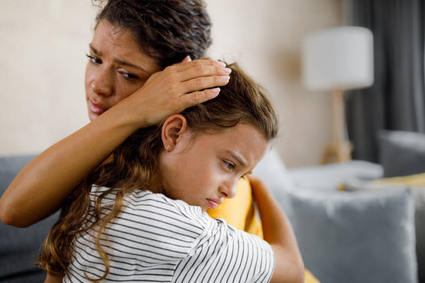 istock Single mother consoling her sad daughter at home. 1356544823