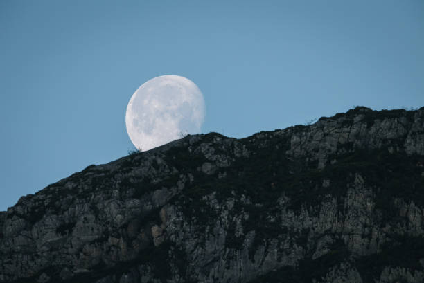 istock Scenic view of moon over mountain range 1356545204