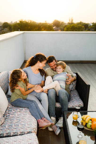istock Happy family having fun on a patio. 1356545383