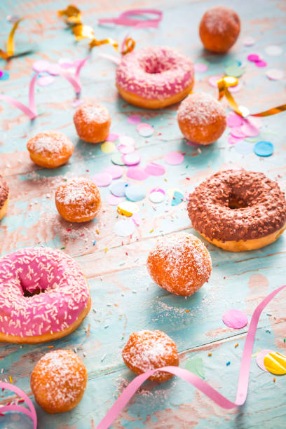istock Krapfen, Berliner and donuts with streamers and confetti 1356546160
