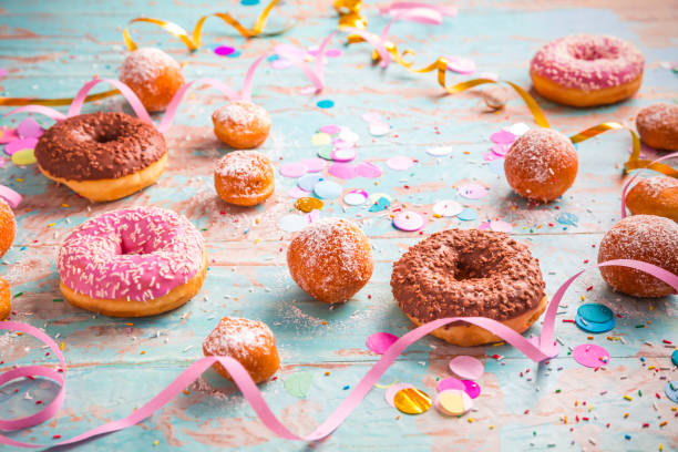 istock Krapfen, Berliner and donuts with streamers and confetti 1356546586