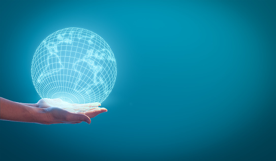 Woman's hands holding the earth globe on a blue background. Global business concept.