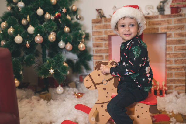 istock Happy Kid front of Christmas Tree 1356548863