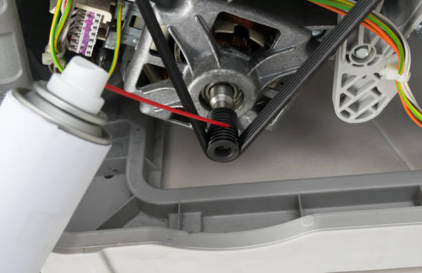 istock the process of lubricating moving elements, washing machine components, close-up 1356550511