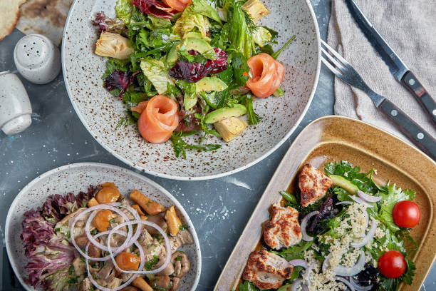 istock Food concept, table with various snacks placed on it. Salad with salmon, caesar skuric, pickled mushrooms, bread 1356550605