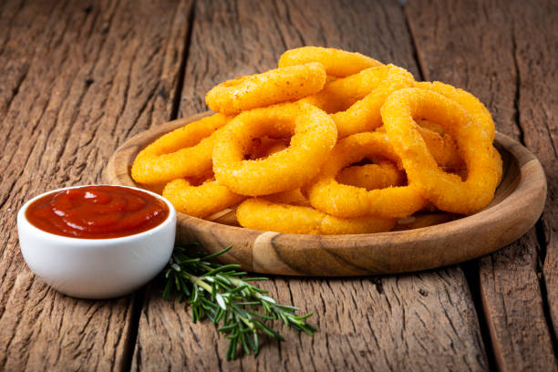 istock Crispy onion rings with ketchup. 1356550679