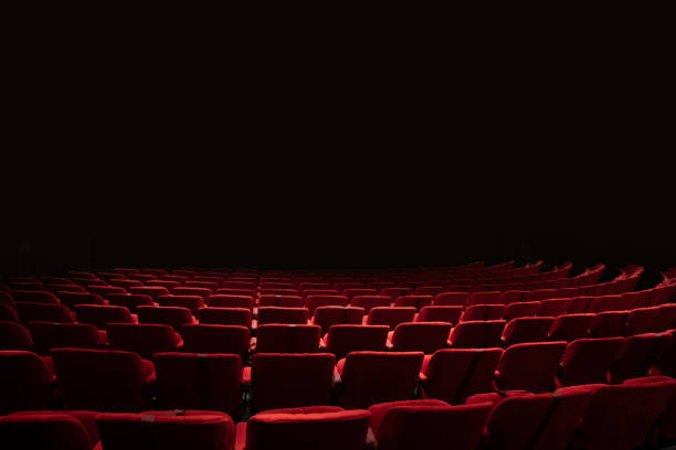 One red empty seat among others black seats in cinema hall. 3d illustration