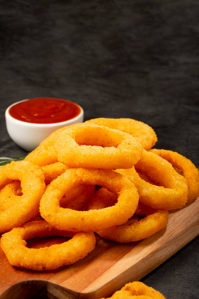 istock Crispy onion rings with ketchup. 1356551897