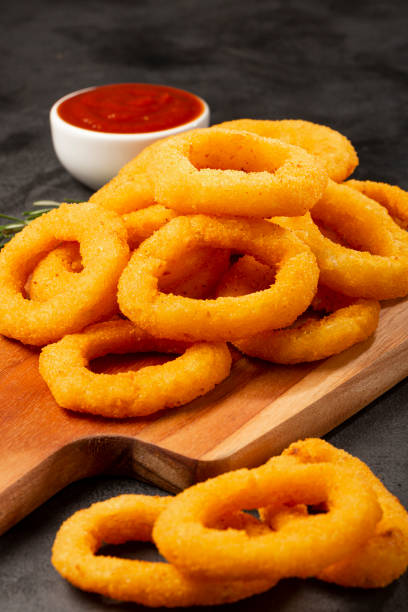 istock Crispy onion rings with ketchup. 1356551902