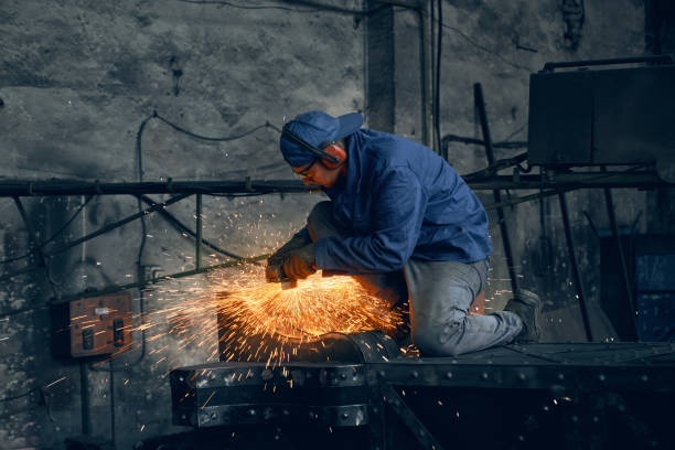 istock Qualified welder working with metal frame indoors 1356551962