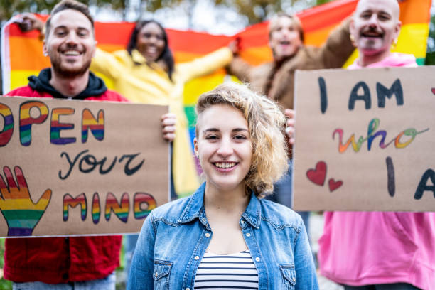 happy multiracial people from different generation celebration gay parade, portrait of a gender fluid young woman happy multiracial people from different generation celebration gay parade, portrait of a gender fluid young woman transgender protest stock pictures, royalty-free photos & images