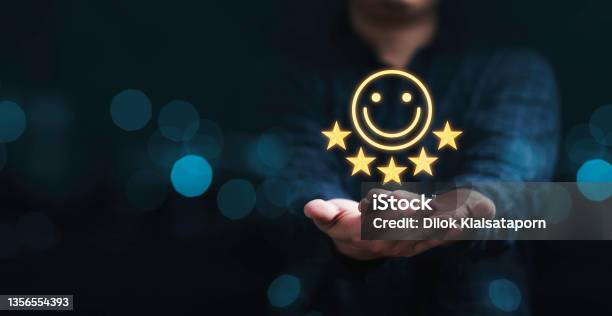 Businessman Holding Smile Icon For The Best Evaluation Customer Satisfaction Concept Stock Photo - Download Image Now