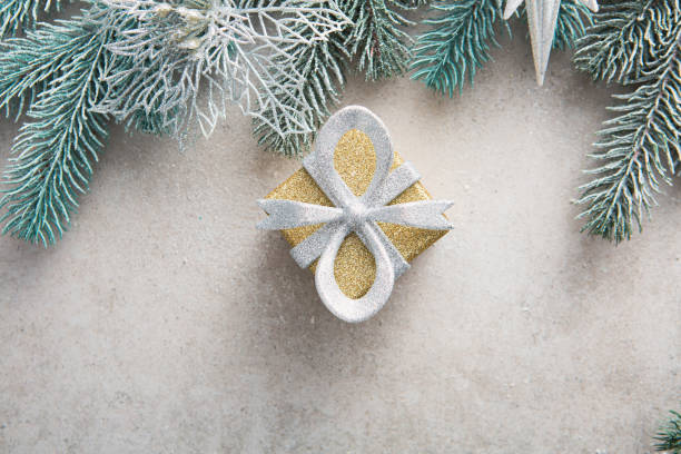 istock Overhead view of Christmas present box and green branches 1356554542
