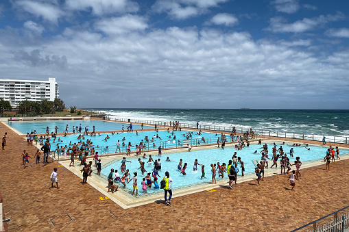 Cape Town, South Africa - November 6, 2019: Sea Point Pavillon Swimming Pool against sea and blue sky