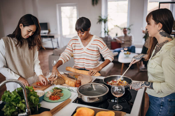 istock Girlfriends reparing meal for dinner party 1356557054