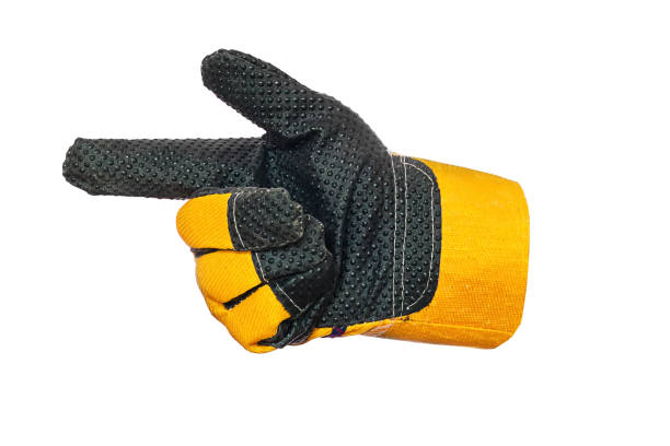 istock Construction glove yellow. Index finger points to side. Isolated object on white background. Symbol or sign 1356557214