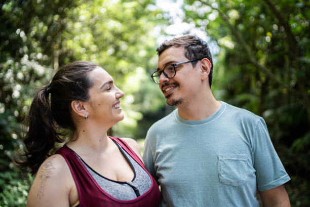 istock Happy friends looking at each other in a trail 1356557783