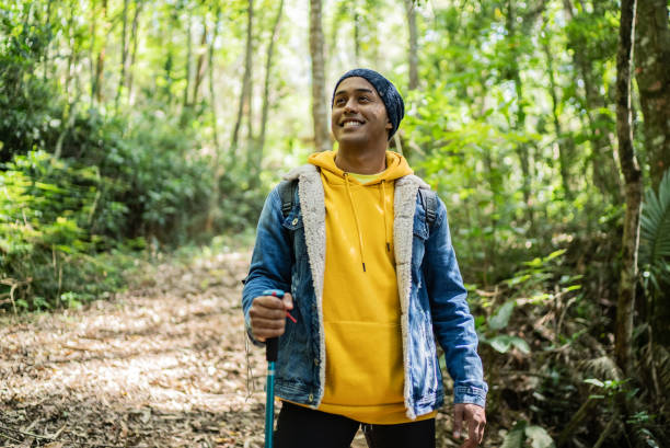 Young man looking away and contemplating in a trail