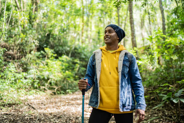 istock Young man looking away and contemplating in a trail 1356557802