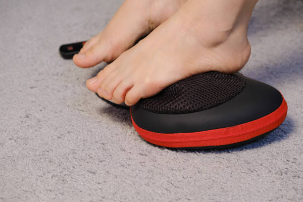 Women's legs and electric automatic massager, foot massage with a massage pillow.