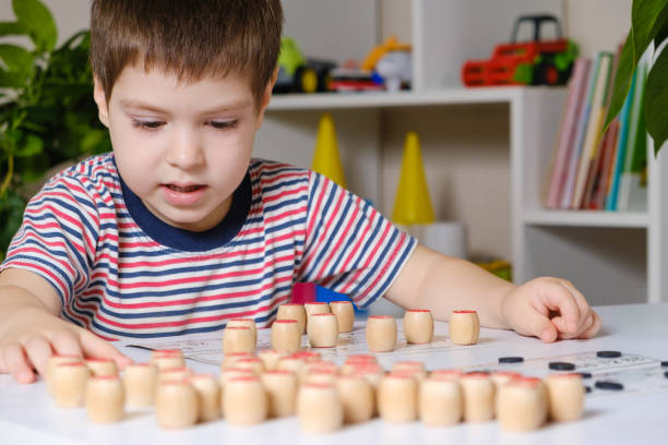 istock A 4-year-old boy plays loto, studies numbers using a board game. 1356560364
