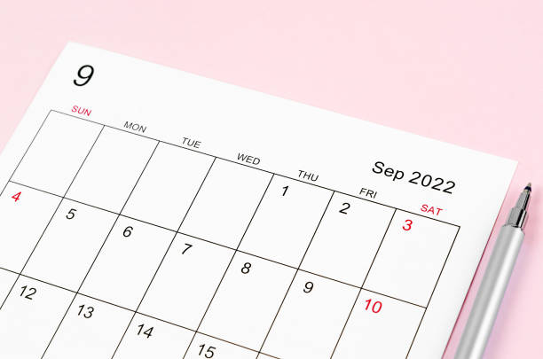 istock September 2022 calendar sheet with pen on pink background. 1356560920